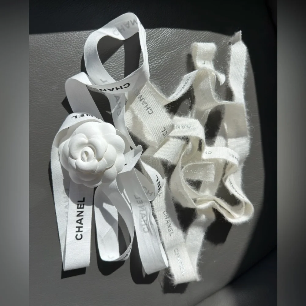 CHANEL 1 CAMELIA FLOWER AND Silver Chanel printed RIBBON,  plus Chanel card.